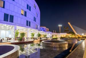 a hotel with two pools in front of a building at Barceló Sevilla Renacimiento in Seville