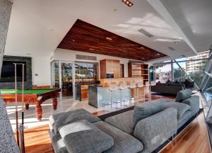 a living room with a couch and a pool table at Reflection on the Sea in Gold Coast