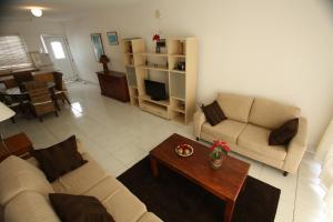 a living room with two couches and a coffee table at Pissouri Beach Apartments in Pissouri