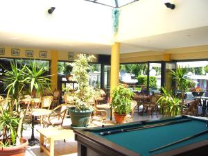 a pool table in a patio with tables and chairs at L'Eden Vacances in Biot