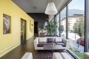 ein Wohnzimmer mit einem Sofa und einem Tisch in der Unterkunft ibis Locarno in Locarno