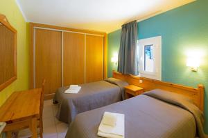 Llit o llits en una habitació de Apartaments Giberga