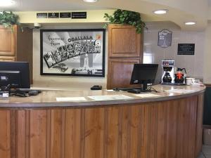 a restaurant with a counter with two computers on it at Super 8 by Wyndham Ogallala in Ogallala