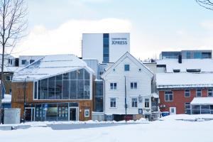 a group of buildings in a city in the snow at Comfort Hotel Xpress Tromsø in Tromsø