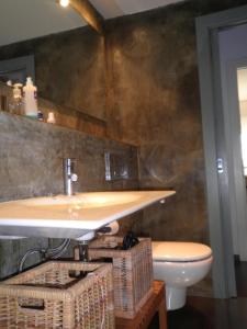 a bathroom with a sink and a toilet at Bacrou apartment, design loft near the sea in Barcelona