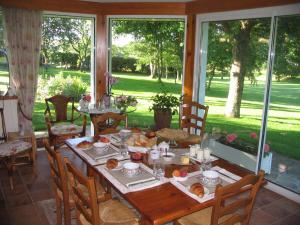 uma sala de jantar com uma mesa com comida em Chambre d'Hôtes Entre Mer et Monts em Plomodiern