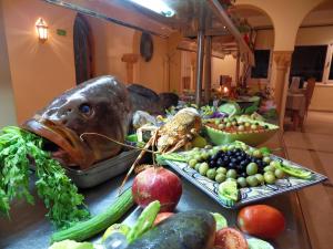 a table with a bunch of fruits and vegetables on it at Hôtel LES MIMOSAS TABARKA in Tabarka