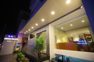 a building with a balcony with a restaurant at Prime Palace Hotel - MG Road in Cochin