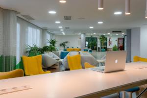 an office with a table and yellow chairs at Relaxia Lanzaplaya in Puerto del Carmen +37 photos
