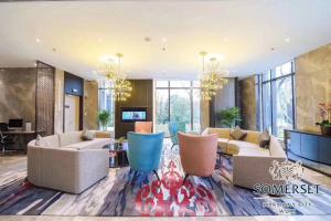 a large living room with couches and a table at Somerset Harmony City Wuxi in Wuxi