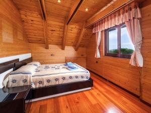 a bedroom with a bed in a wooden room at Holiday Home Irisada by Interhome in Fogás de Tordera