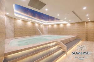 a jacuzzi tub in a large room with at Somerset Harmony City Wuxi in Wuxi
