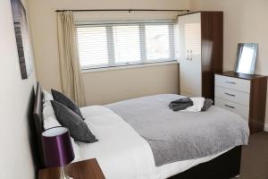 a bedroom with a large bed and a window at Parks Nest 5 in Hull