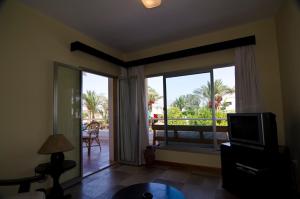 a living room with a tv and a sliding glass door at Oonas Dive Club in Sharm El Sheikh