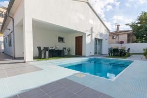 a swimming pool in the backyard of a house at Llevant in Can Picafort