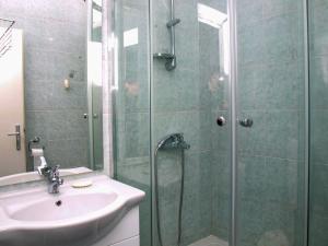 a bathroom with a sink and a glass shower at Apartments Vukovic in Postira +74 photos