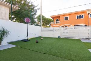 a backyard with a soccer ball on the grass at Llevant in Can Picafort