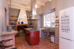a large kitchen with a stove and a refrigerator at La Penya in Sa Pobla +7 photos
