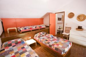 a room with three beds and a mirror at Villino Lacona in Capoliveri