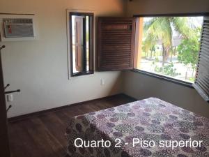 Un pat sau paturi într-o cameră la Casa Beira Mar - Guadalupe Gamela