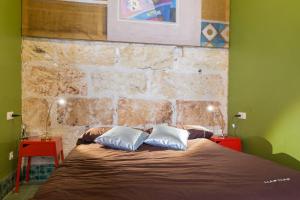 a bedroom with a bed with two pillows on it at La Penya in Sa Pobla
