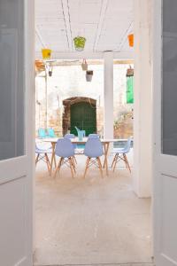 a table and chairs in a room with a brick wall at La Penya in Sa Pobla