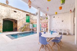 a patio with a table and chairs and a pool at La Penya in Sa Pobla