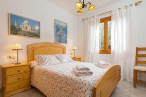 a bedroom with a bed with two towels on it at Calma in Son Serra de Marina +23 photos