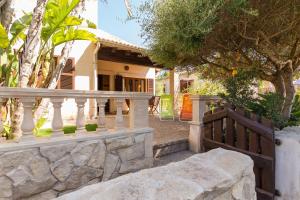 a stone fence in front of a house at Alga Marina in Son Serra de Marina