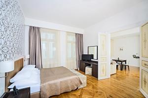 a hotel room with a bed and a desk at Deminka Palace in Prague