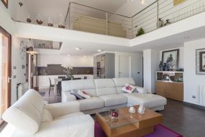 a living room with a white couch and a table at Sa Riba in Muro