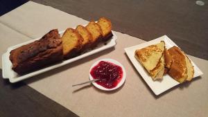 a table with two plates of cake and a bowl of sauce at Chambre d'Elisabeth à la Ferme in Montépilloy
