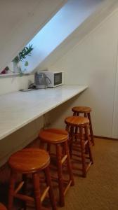 a kitchen with three stools and a counter with a microwave at ubytování v apartmánu in Mladkov +20 photos