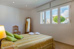 アルクーディアにあるCan Vauma Lakeのベッドルーム1室(緑の枕が付くベッド1台、窓付)