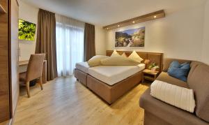 Postel nebo postele na pokoji v ubytování Hotel Garni Fiegl Apart