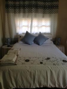 En eller flere senge i et værelse på MulMas Guest House