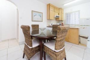 a kitchen and dining room with a table and chairs at Pissouri Beach Apartments in Pissouri