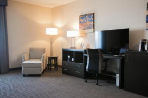 a hotel room with a desk and a chair and a computer at Holiday Inn Longview - North, an IHG Hotel in Longview