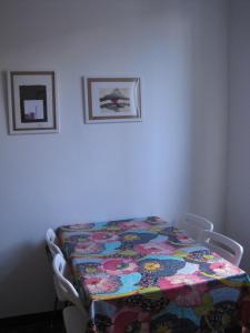 a table with a quilt on it in a room at Una Porta sul Porto Antico in Genova +6 photos