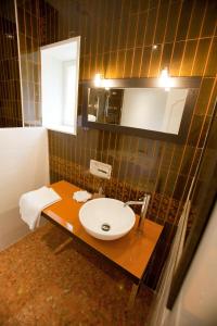 a bathroom with a sink and a mirror at Château de Bellevue B&B in Villié-Morgon