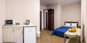 a hotel room with a bed and a table with fruit at Apart Hotel Smart Studio in Kharkiv