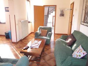 ein Wohnzimmer mit 2 Stühlen und einem Couchtisch in der Unterkunft Como Country House in Cavallasca
