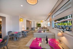 a restaurant with tables and chairs and a window at Villa Bettina in La Baule