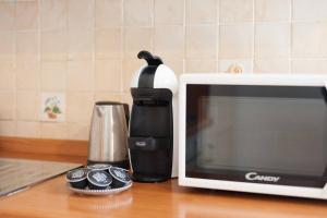 a kitchen counter with a microwave and a coffee maker at Love weekend near Piazza Ognissanti in Florence