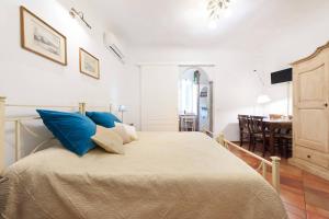 a bedroom with a large bed with blue pillows at Love weekend near Piazza Ognissanti in Florence