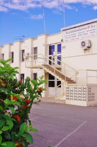 a white building with a staircase in front of it at Accommodation @ Isa in Mount Isa