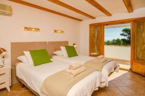 two beds in a room with a window at Villa Miramar, Luxury Villa Rental - Javea in Balcon del Mar +51 photos