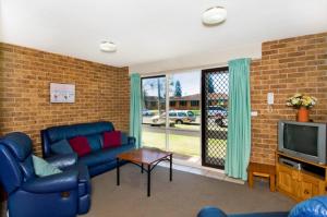 a living room with a couch and a tv at Bay Park Gardens 30 1 Warlters Street in Port Macquarie