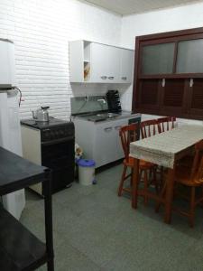 a kitchen with a table and chairs and a stove at Giuseppe & Giuseppin in Torres