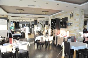 a dining room with tables and chairs in a restaurant at Apartments Milmari M 6.7.8 in Kopaonik